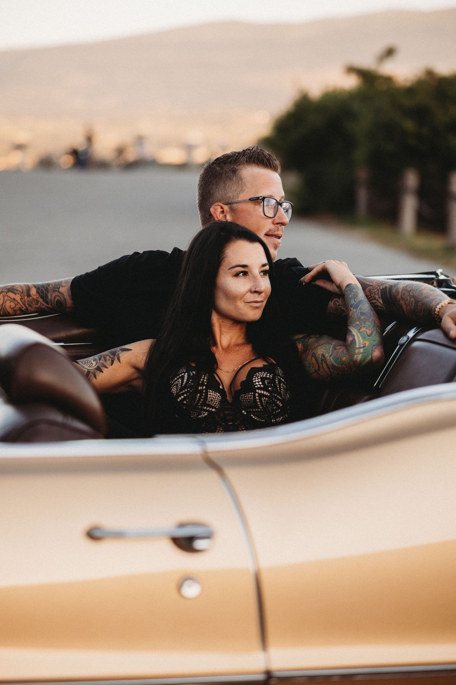 Couple enjoying a vintage car engagement session at sunset at Knox mountain in Kelowna, BC.
