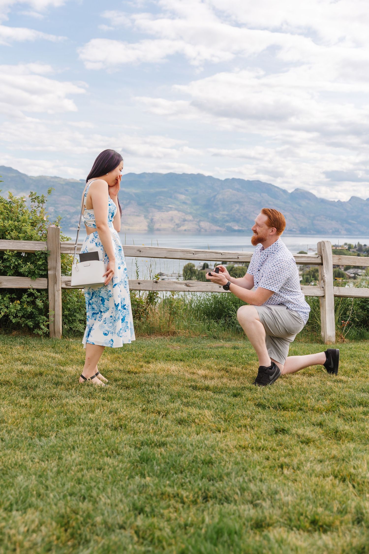 Photoshoot of Surprise proposal at Quails Gate Winery in West Kelowna, BC with a view of Okanagan Lake in the background.