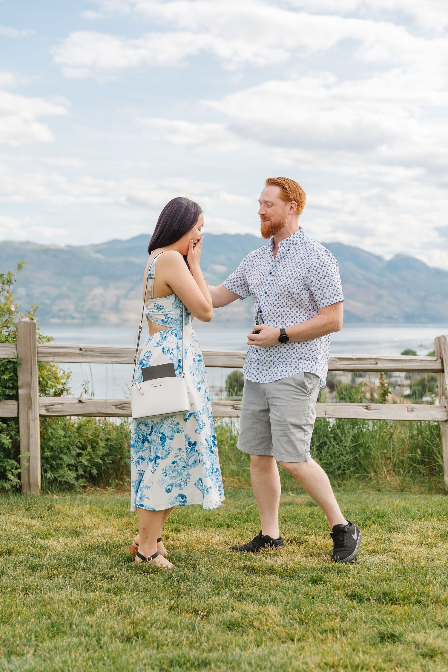 Photoshoot of Surprise proposal at Quails Gate Winery in West Kelowna, BC with a view of Okanagan Lake in the background.