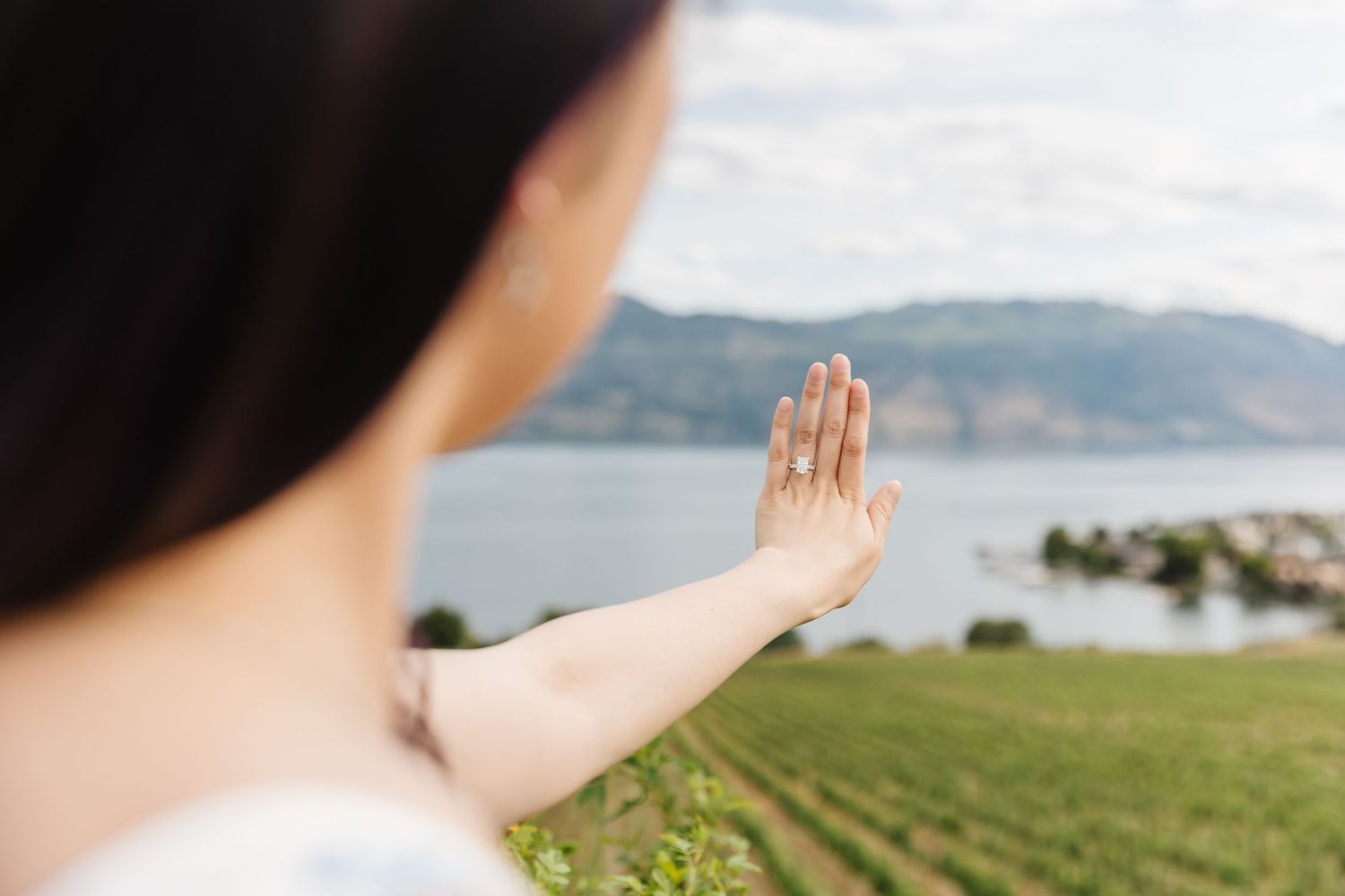 photoshoot of Engagement ring with view of vineyard and Okanagan Lake at Quails Gate Winery in West Kelowna, BC.
