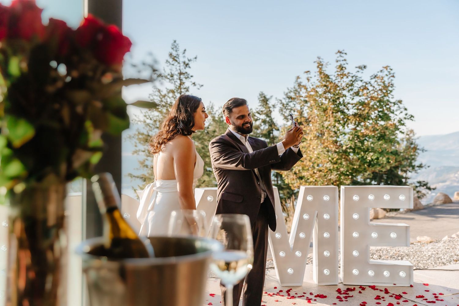couple sharing engagement announcement in Kelowna bc at sparkling hills resort after surprise proposal photoshoot