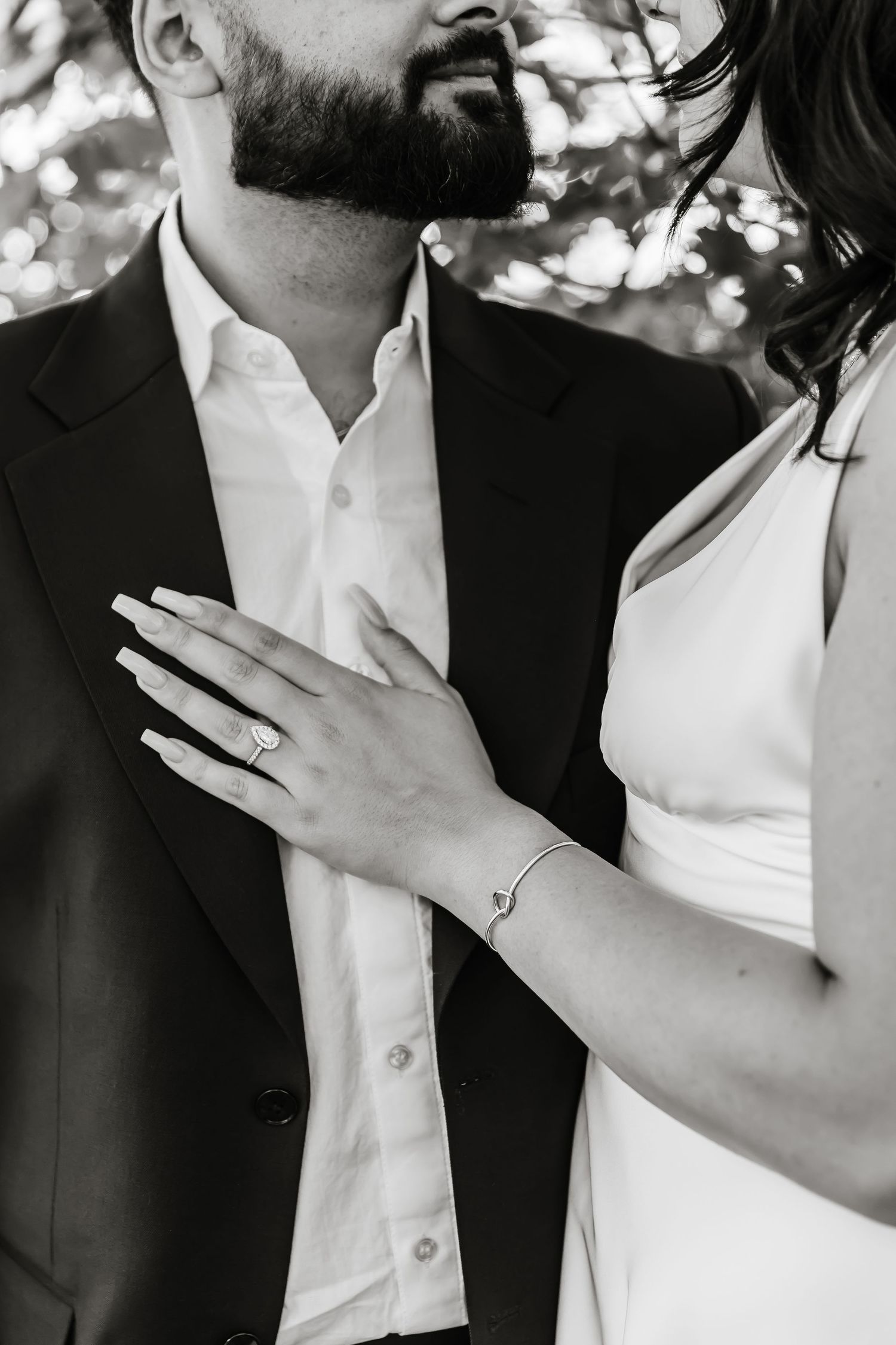 Black and white close-up photo showing hands with an engagement ring in an intimate romantic moment in the Okanagan for engagement photos