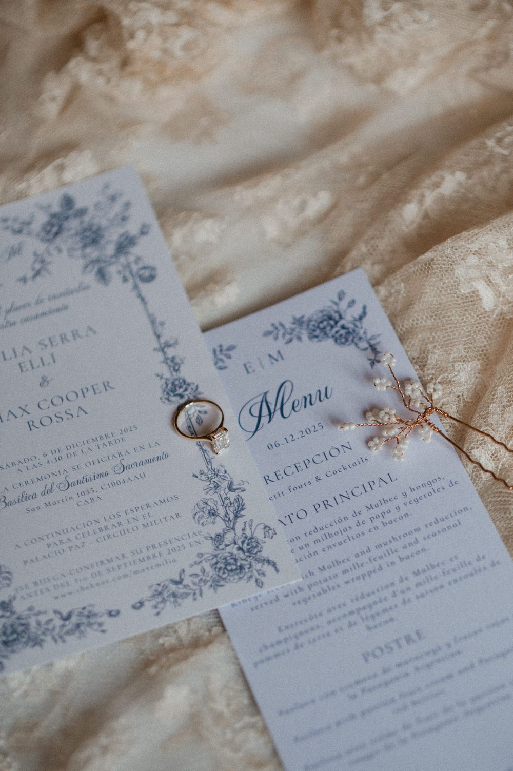 Elegant wedding invitation suite with delicate blue floral designs and calligraphy on cream paper.
