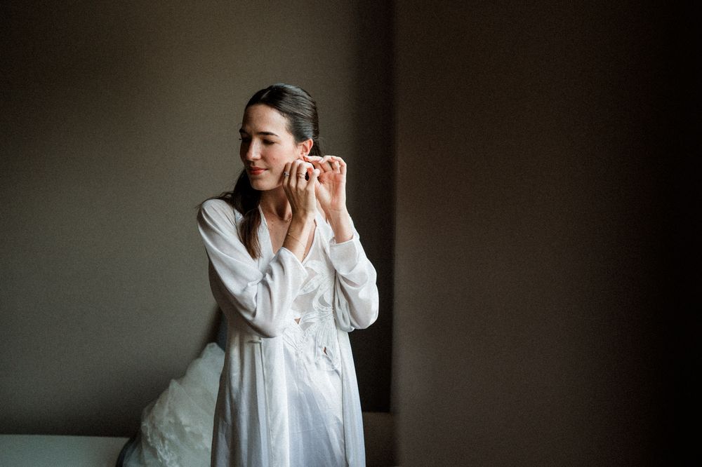 A person in a white dress poses dramatically against a dark background in a series of connected photos.