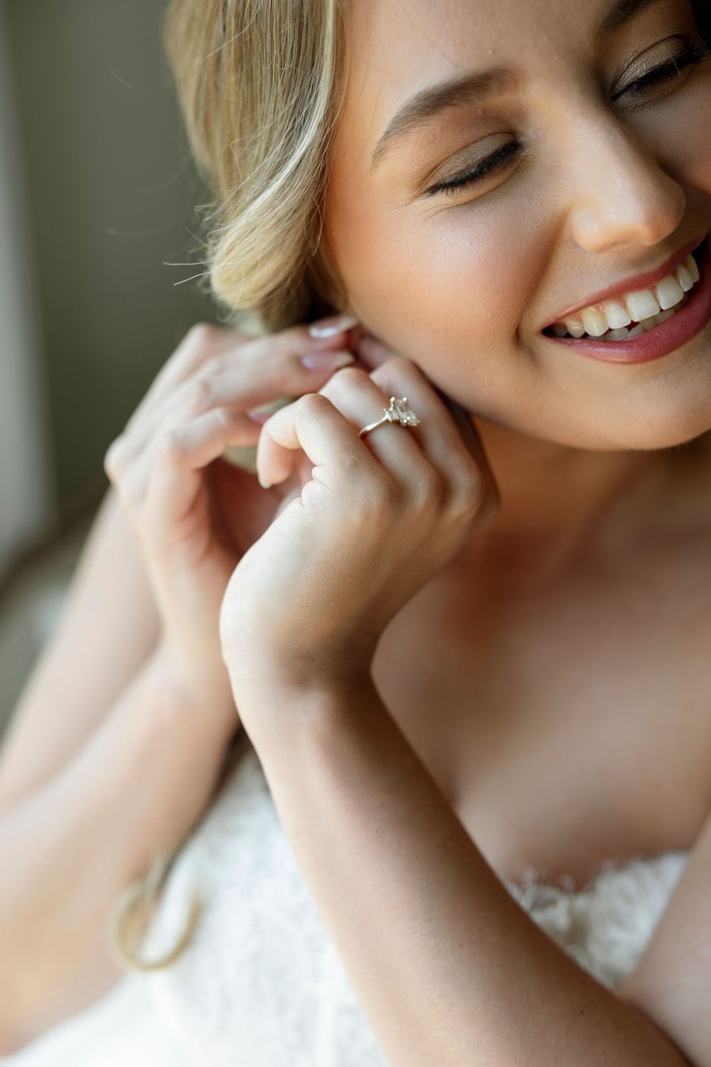 Close-up shots of a bride's joyful expressions and diamond engagement ring in natural lighting.