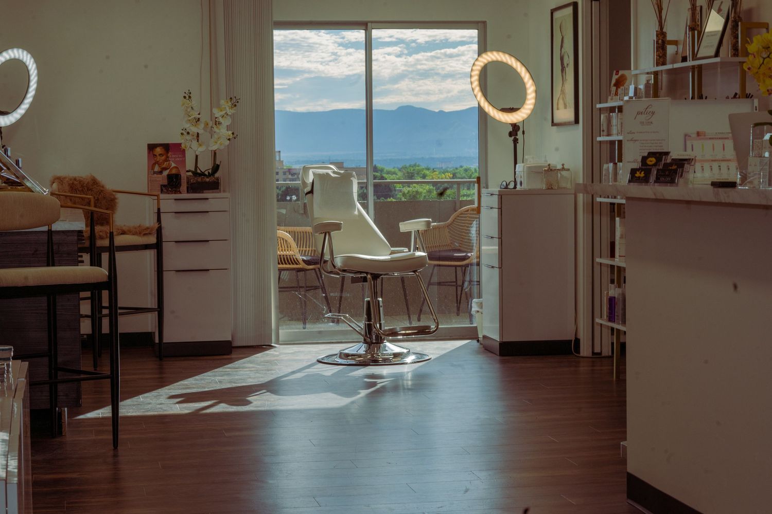 Modern open concept office space with panoramic mountain views through floor-to-ceiling windows.