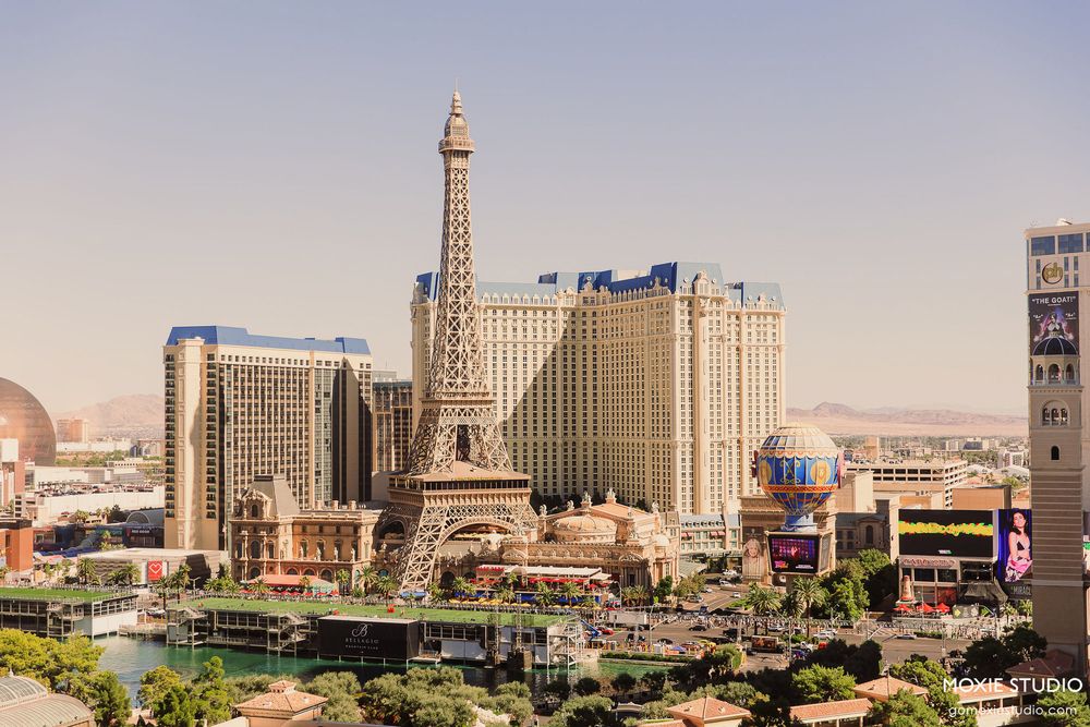 Panoramic cityscape view of Las Vegas Strip showing multiple hotels, casinos and the Eiffel Tower replica.