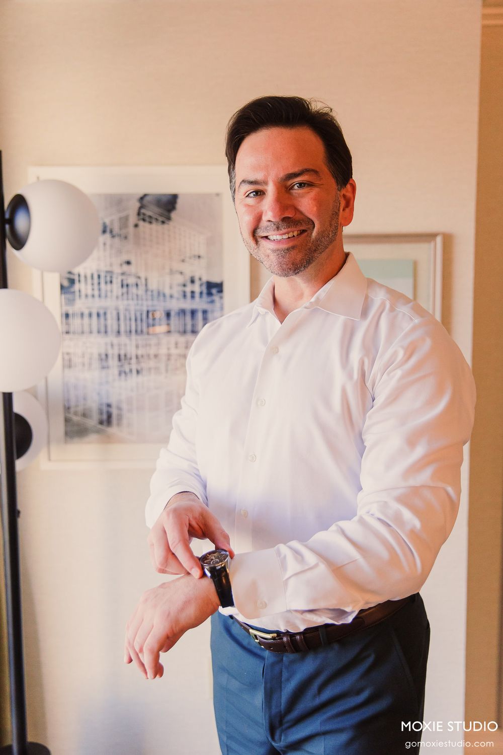 A series of candid getting ready photos showing someone adjusting their white dress shirt sleeves in an indoor setting.
