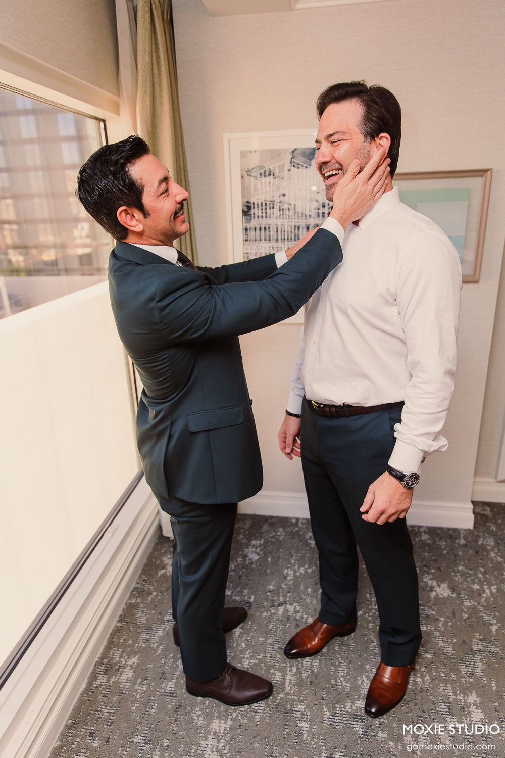 A sequence of playful moments captured between two people in formal attire in a room with framed artwork.