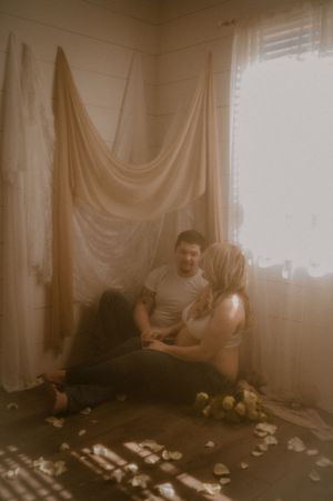 A moody sepia-toned photo sequence showing someone sitting in a room with draped curtains and scattered items on the floor.