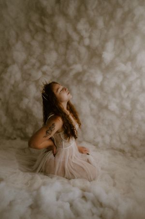Artistic boudoir photography with soft lighting and dreamy textures creating an ethereal mood.