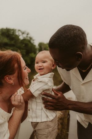 A series of tender moments between parents and child showing kisses and loving interactions in warm muted tones.