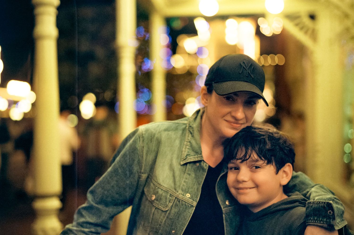 Family members share a warm moment together inside Disney World during evening hours.