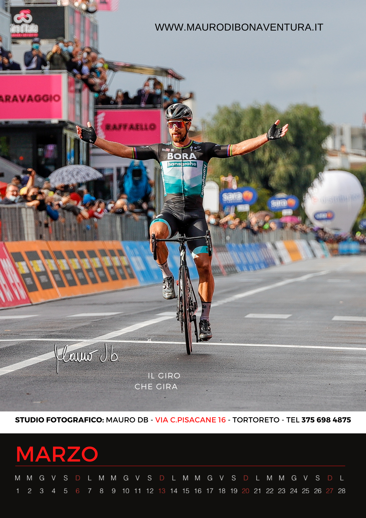 Cyclist celebrating victory at finish line during professional race competition.