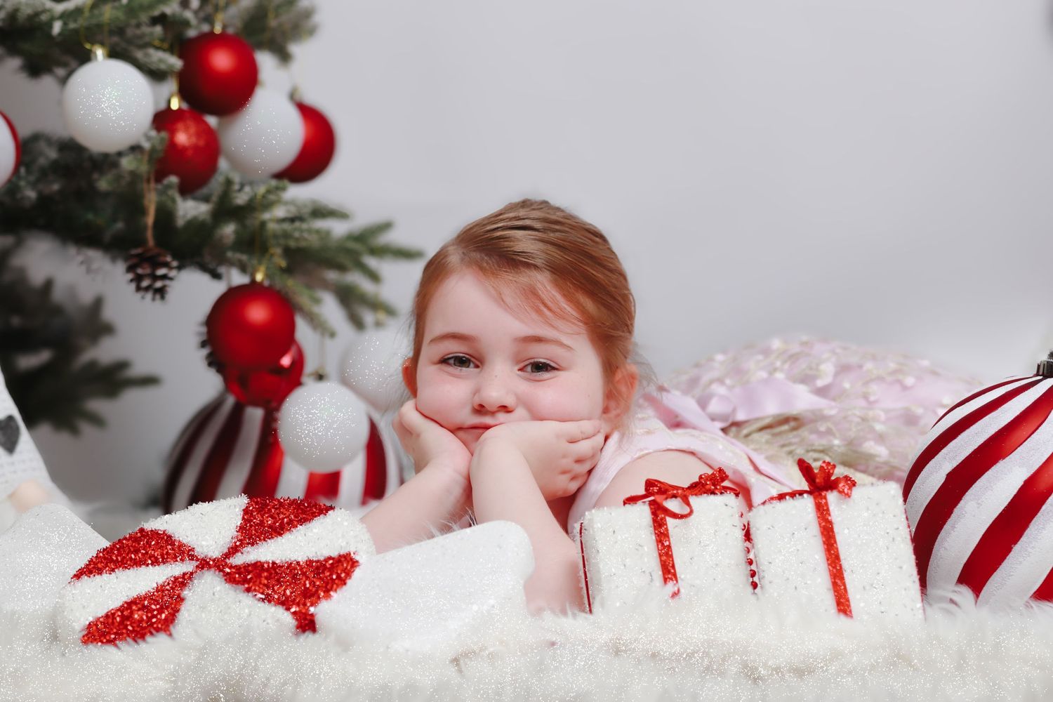 Festive holiday scene with peppermint decorations and wrapped presents.
