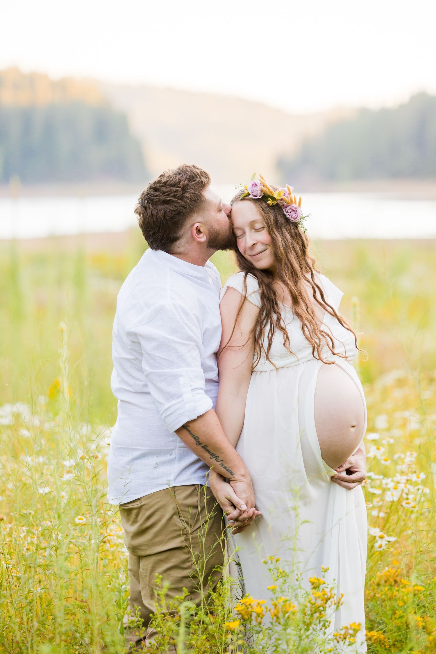 A mother embraces her two young children in a lush garden with cacti, sharing a tender family moment outdoors.