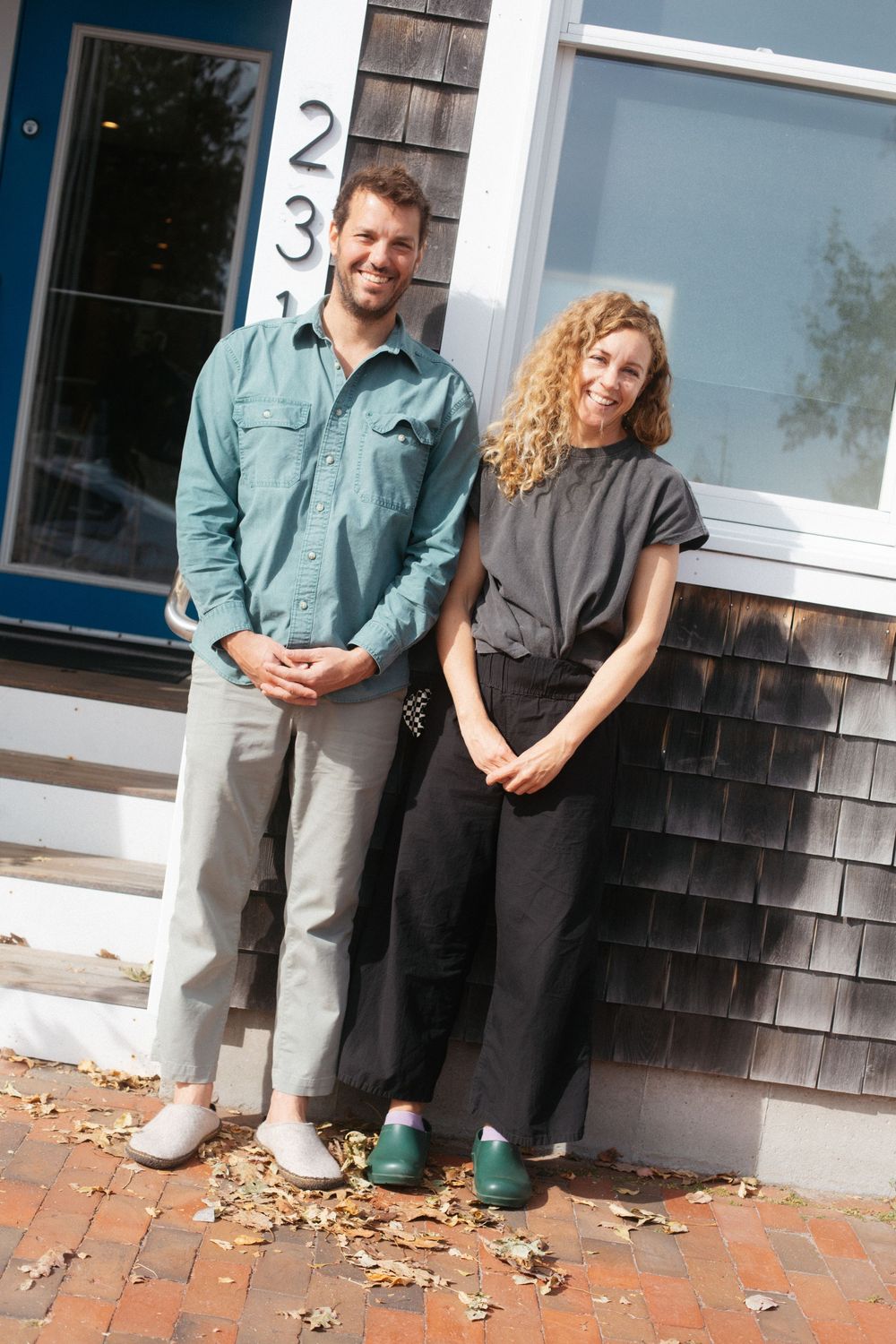 Outdoor photograph of the acupuncturists together in the sunshine outside of their studio in the West End in Portland, Maine.