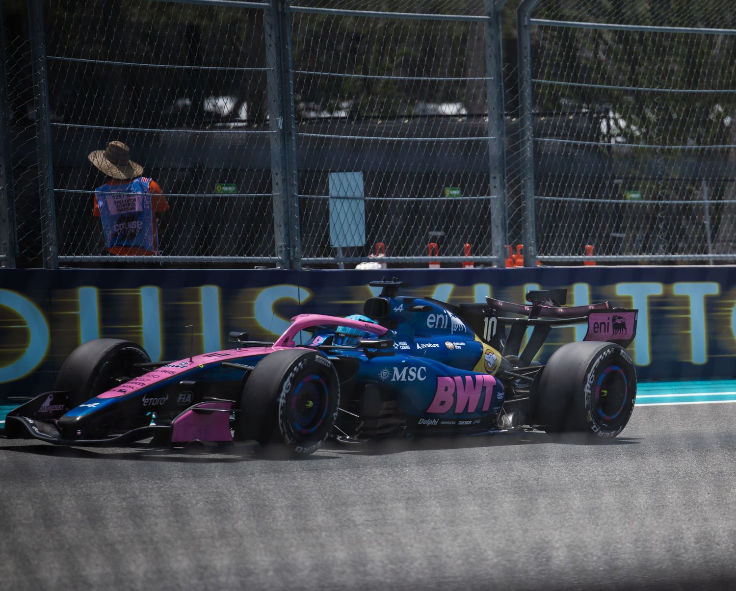 BWT Alpine F1 racing car navigating a street circuit corner during a Formula 1 Grand Prix event.