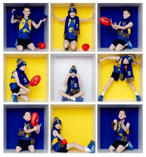 Nine children in West Coast Eagles AFL jerseys and beanies pose with red footballs in yellow and white cube shelves.