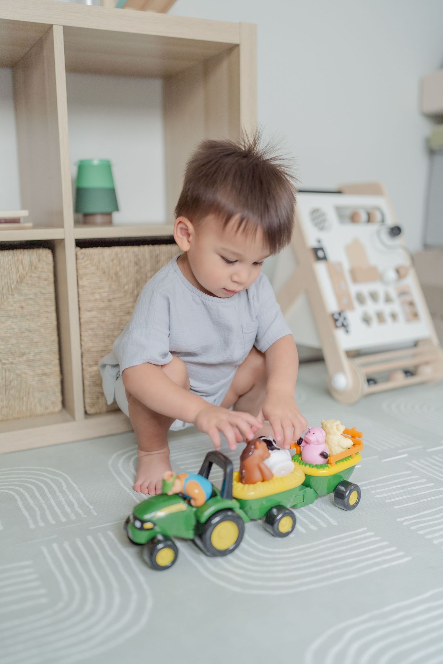 Toddler playing with toys in nursery