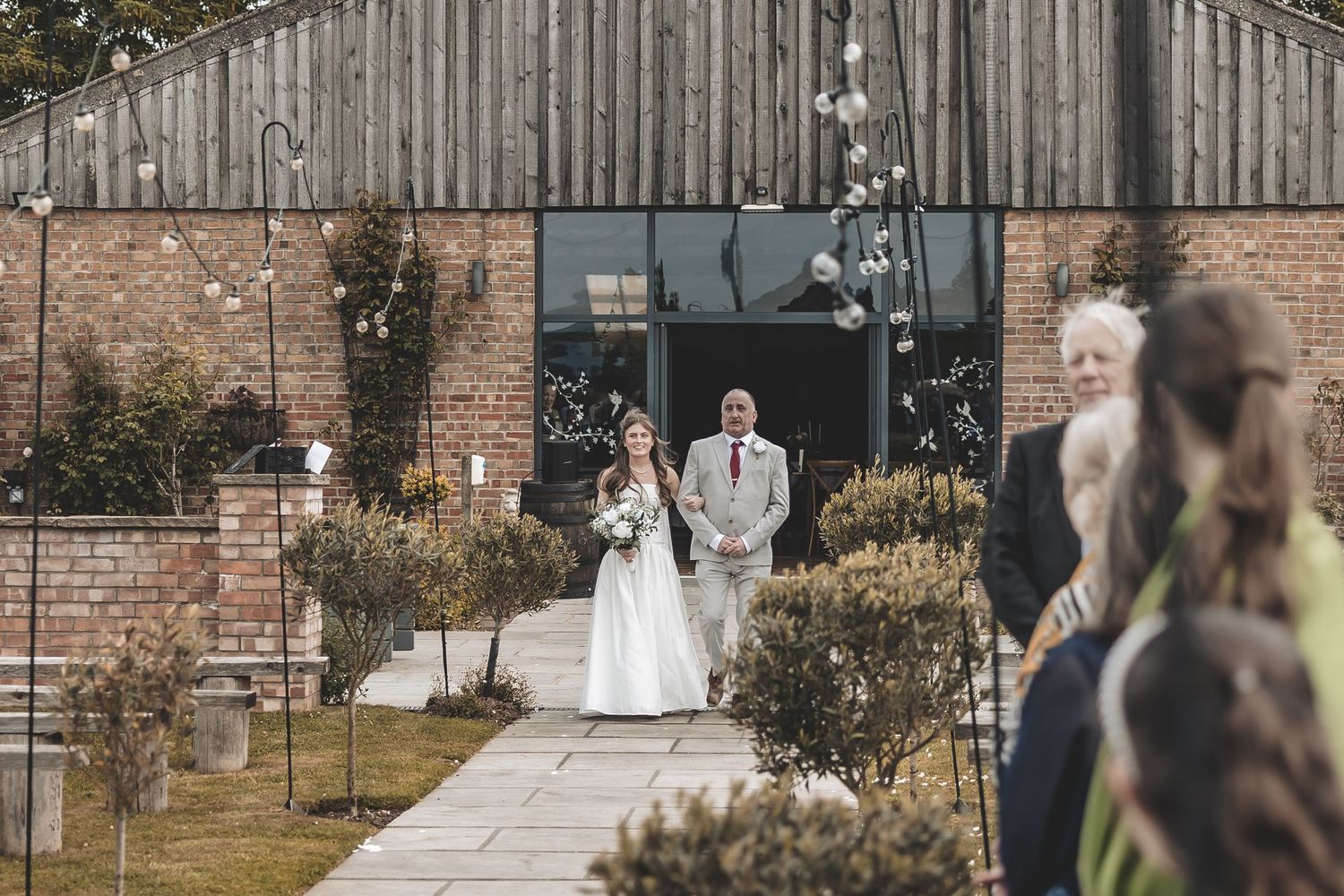 Unobtrusive photo of bride walking down the aisle at Beverley Barn.