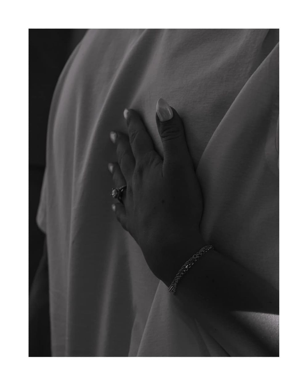 A series of black and white photographs showing hands with blurred edges against a dark background.