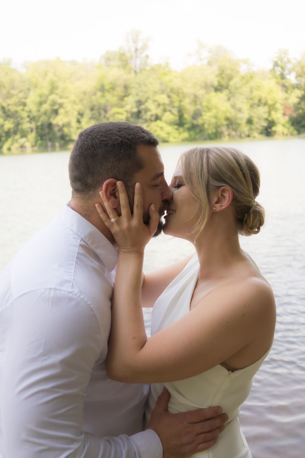 A romantic photoshoot sequence by a lake with soft natural lighting.