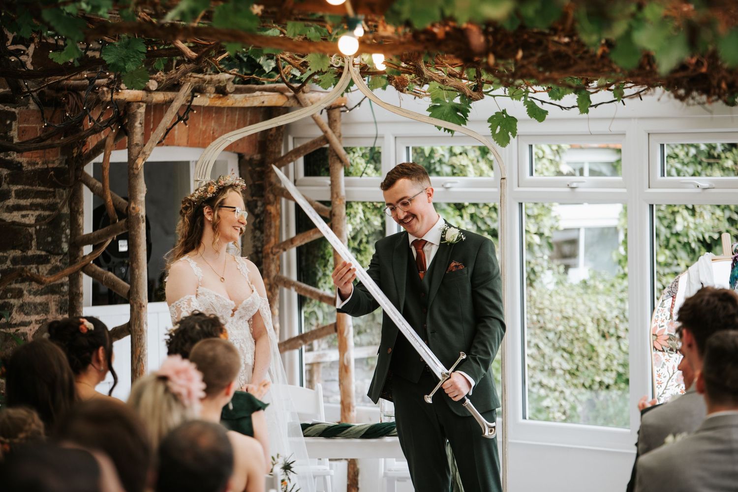 Playful wedding party poses outdoors in casual setting.