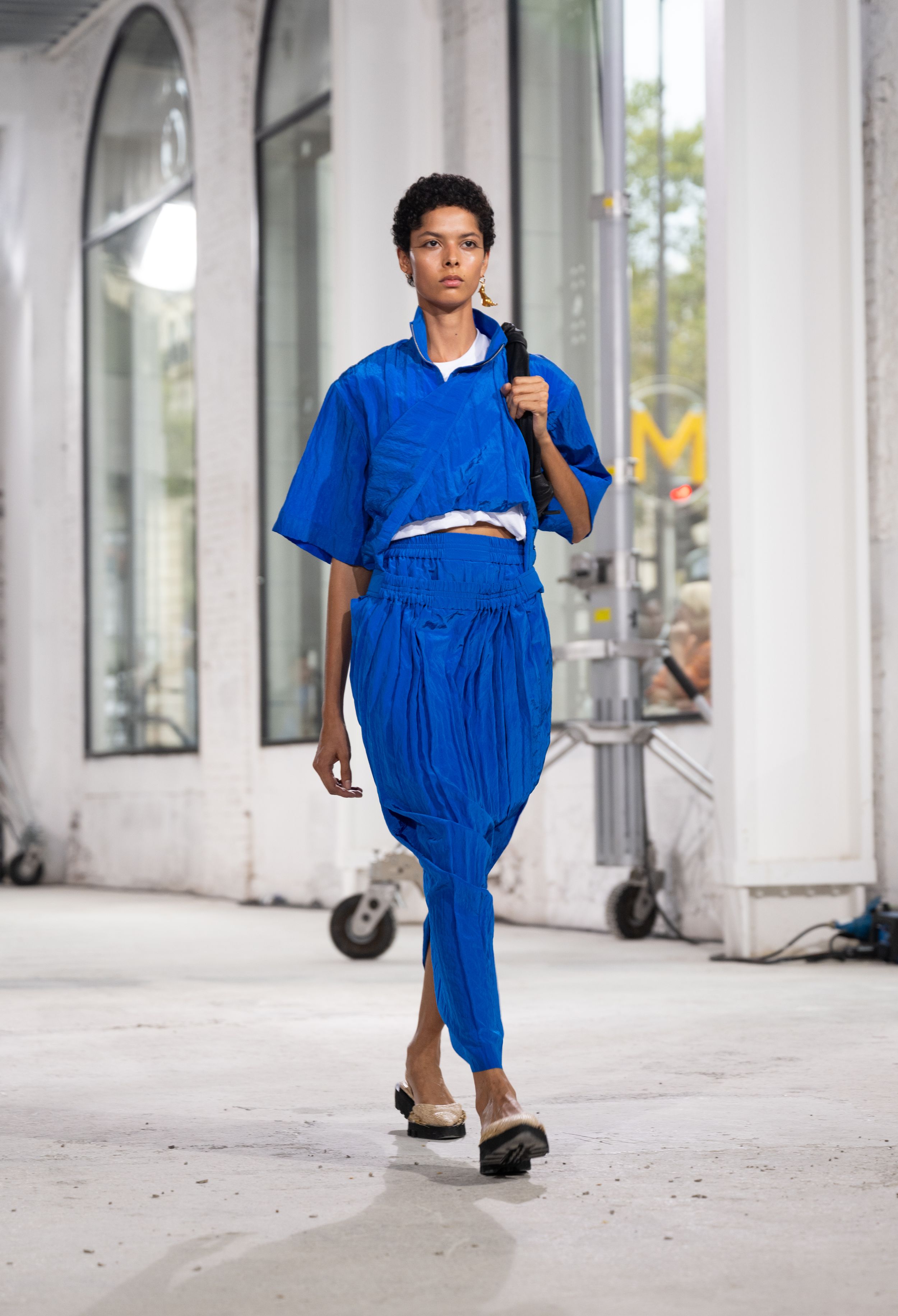Bold electric blue ensemble with kimono-style top and gathered pants on fashion runway.