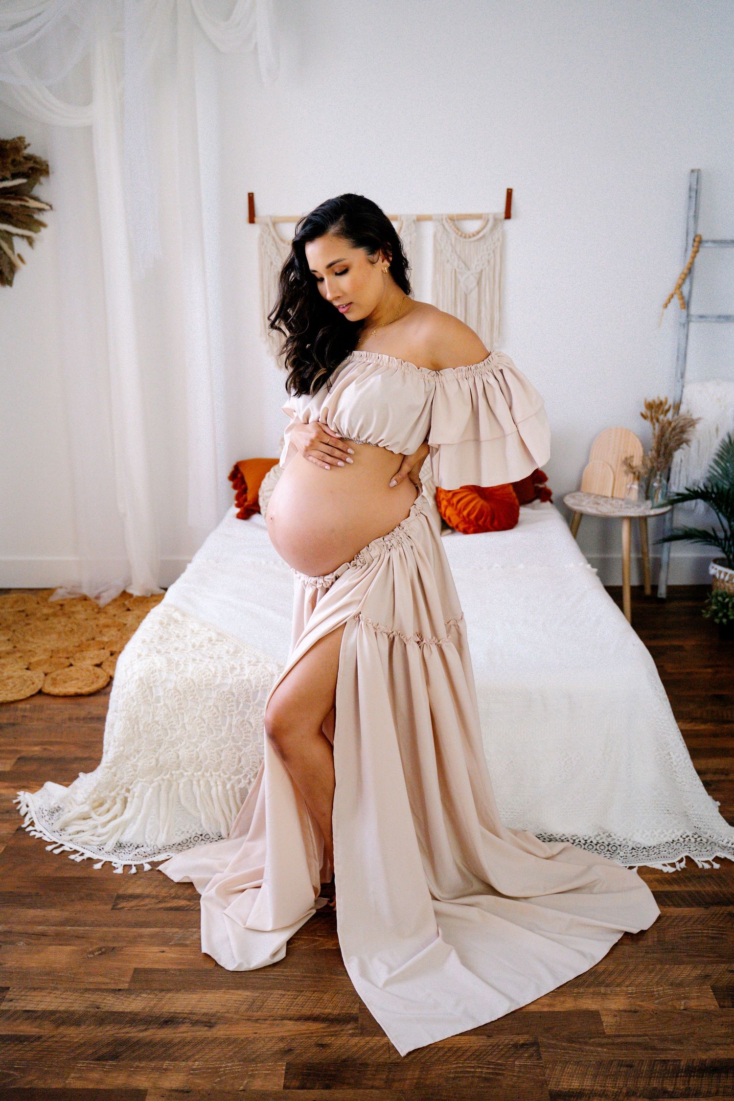 Elegant maternity gown from client closet, available for maternity photoshoots, featuring lace sleeves and a floor-length skirt.