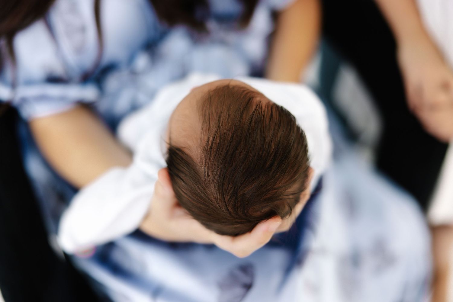 Close-up details of a family photoshoot showing intimate moments on white background.