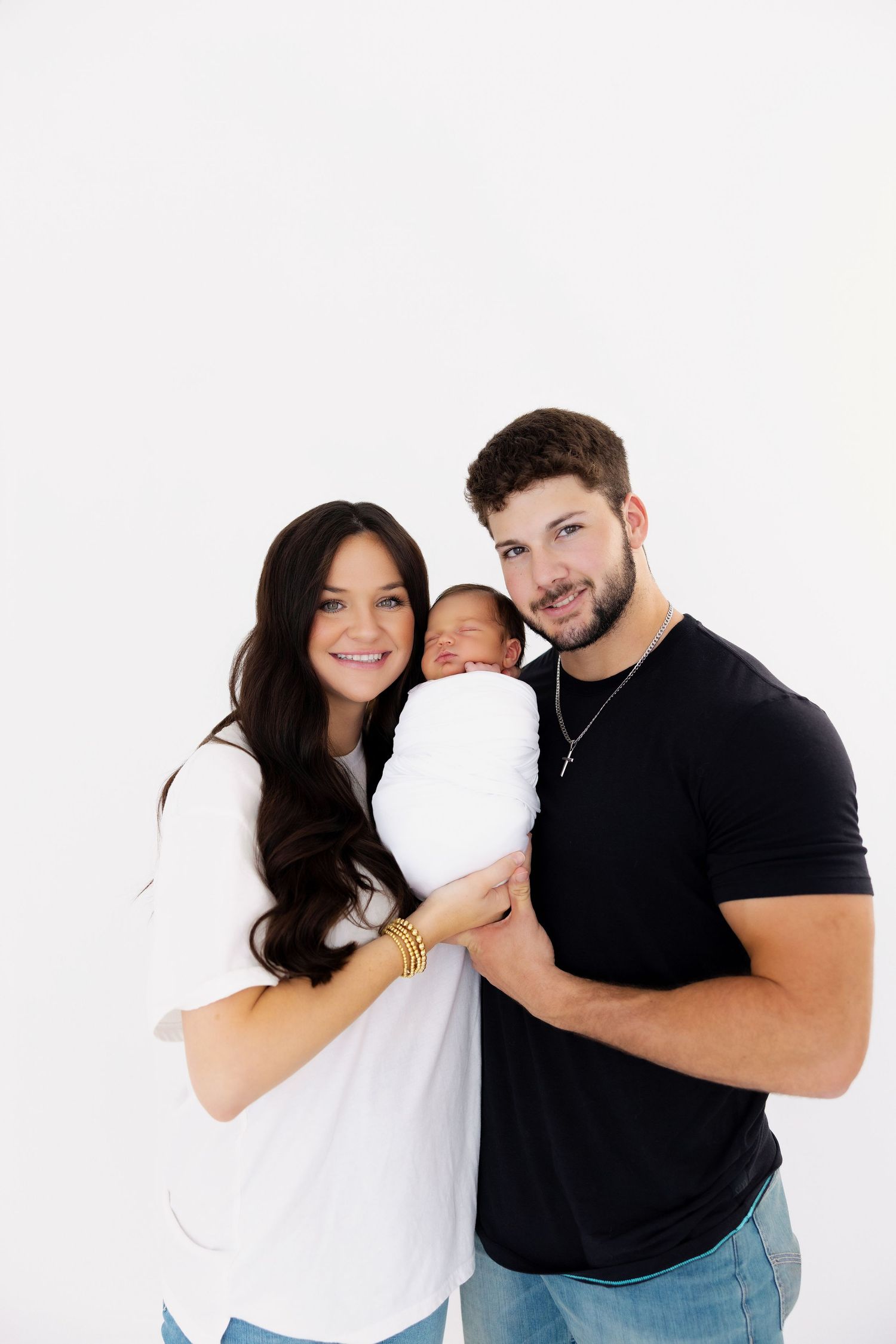 A series of family photos with parents dressed casually while holding their newborn against a white background.