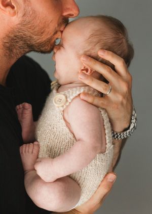 Baby and Dad newborn photography captured at home.  Newborn and family photographer based in Hertfordshire