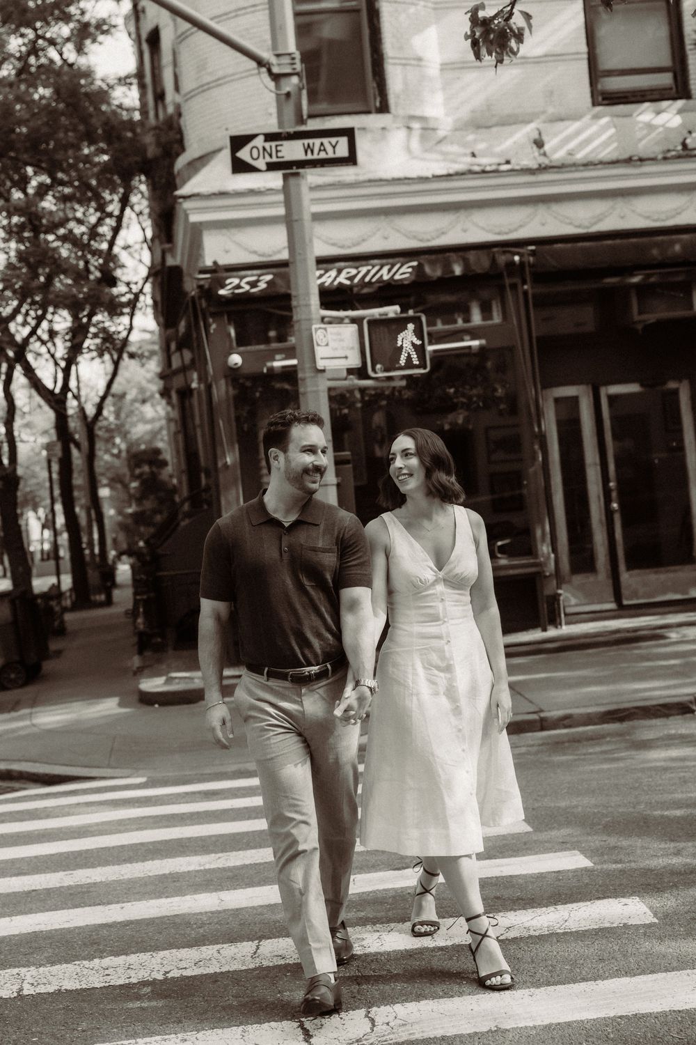 A sequence of black and white photos showing people crossing an urban intersection with a crosswalk sign visible.