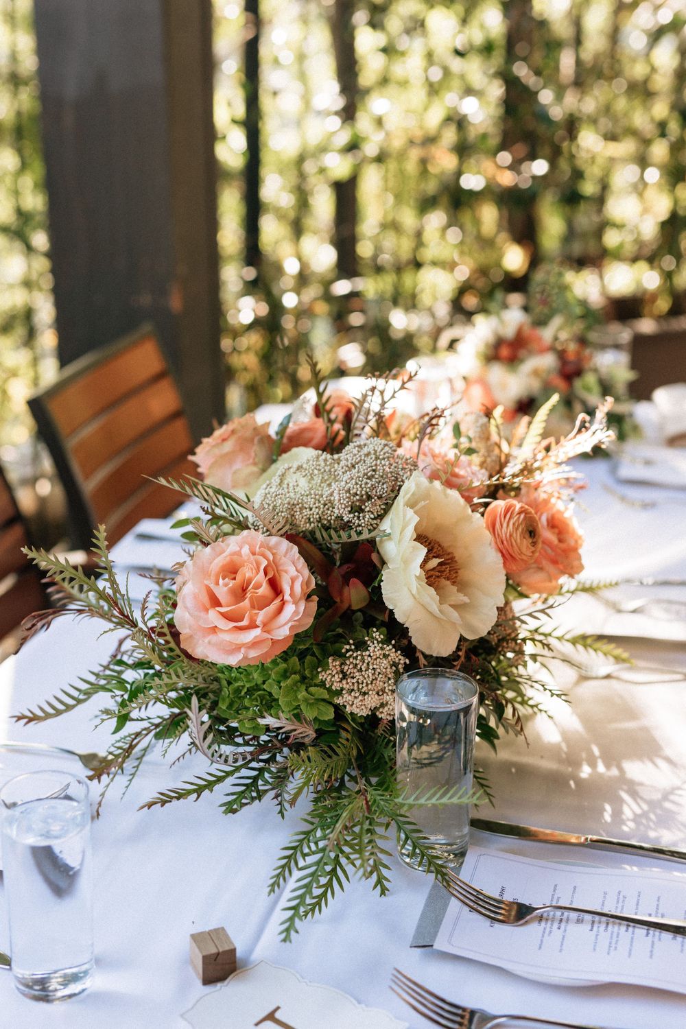 Reception table with candles and simple floral arrangement.