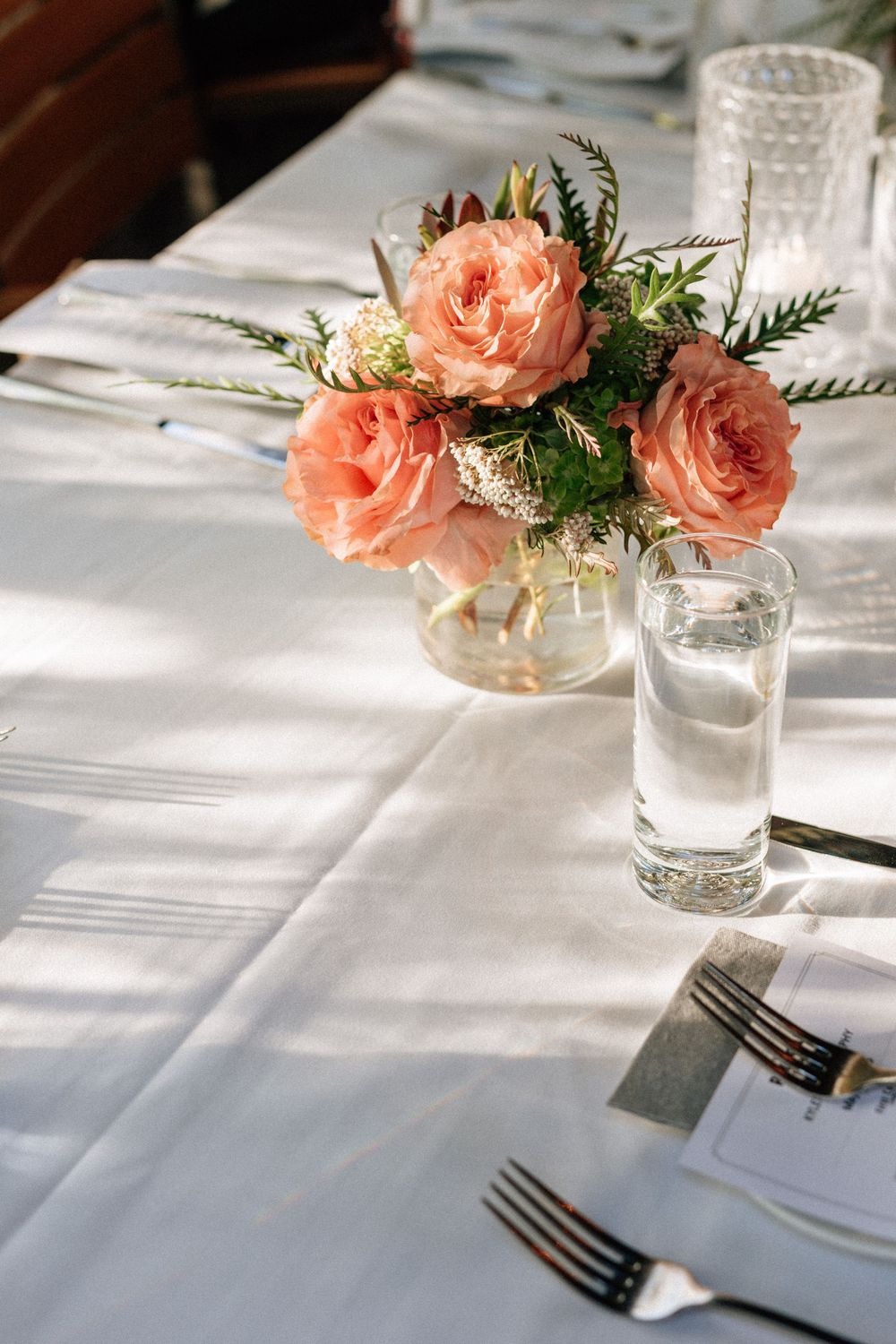 Vintage flatware and linen napkins at cozy restaurant reception.