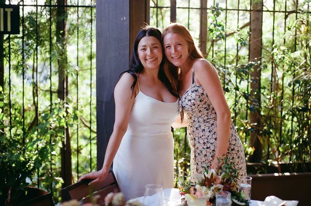 Bride laughing with guests at casual Pasadena wedding dinner.
