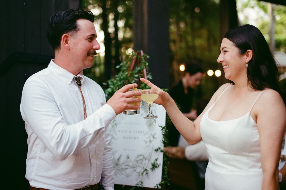 Groom clinking glasses during wedding toast.