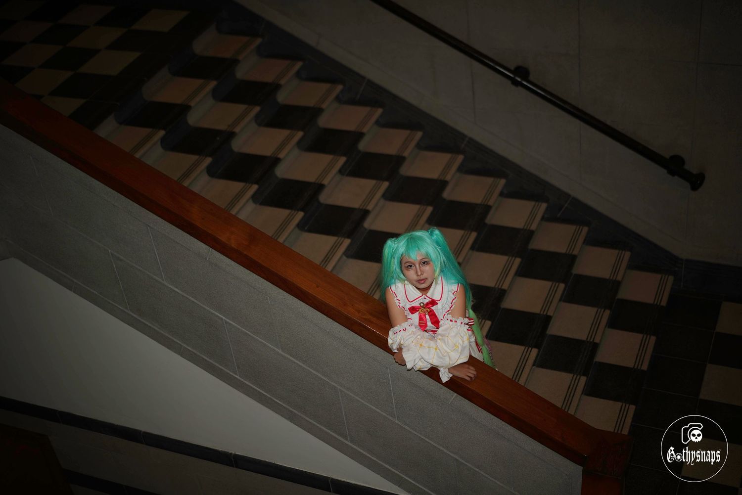 A Hatsune Miku Cosplayer In National Gallery Singapore  Posing at a stair.