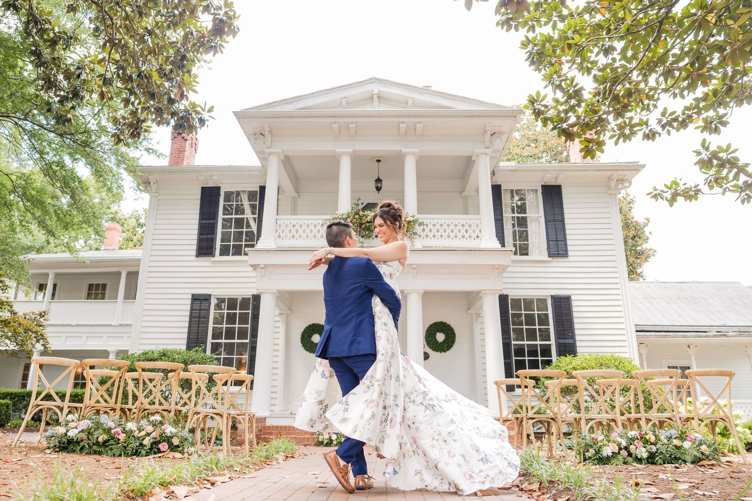 Elegant outdoor wedding photography session at a stately white colonial mansion.