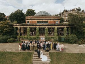 A large group gathered for an outdoor event at a historic building with columned terraces and domed roof in Edinburgh.