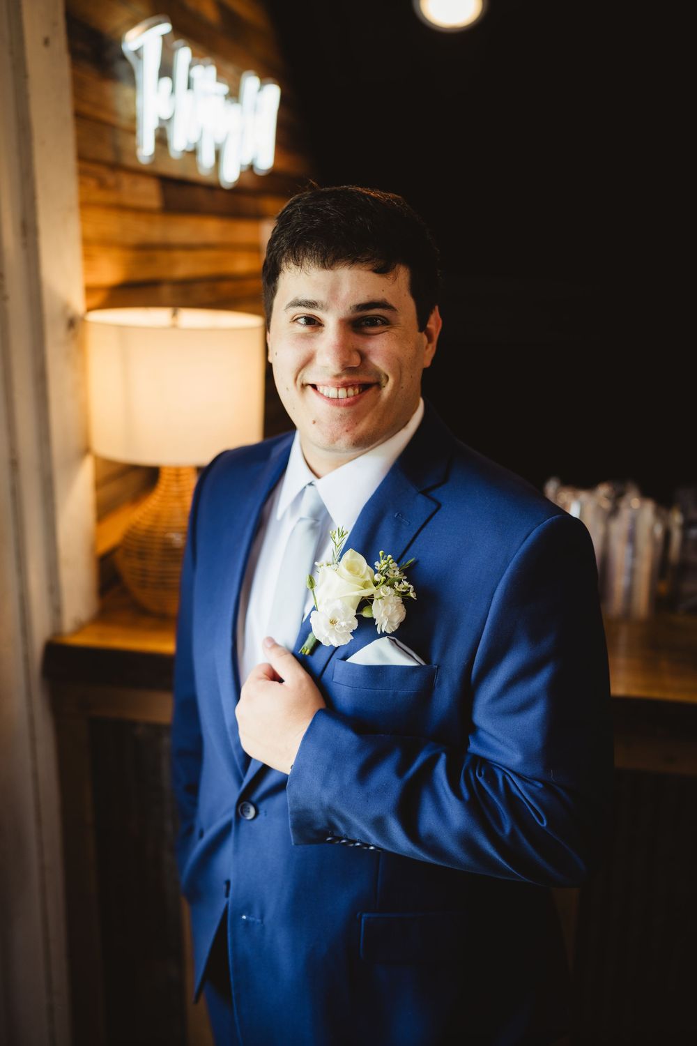Wedding attire featuring a bright royal blue suit with white boutonniere.