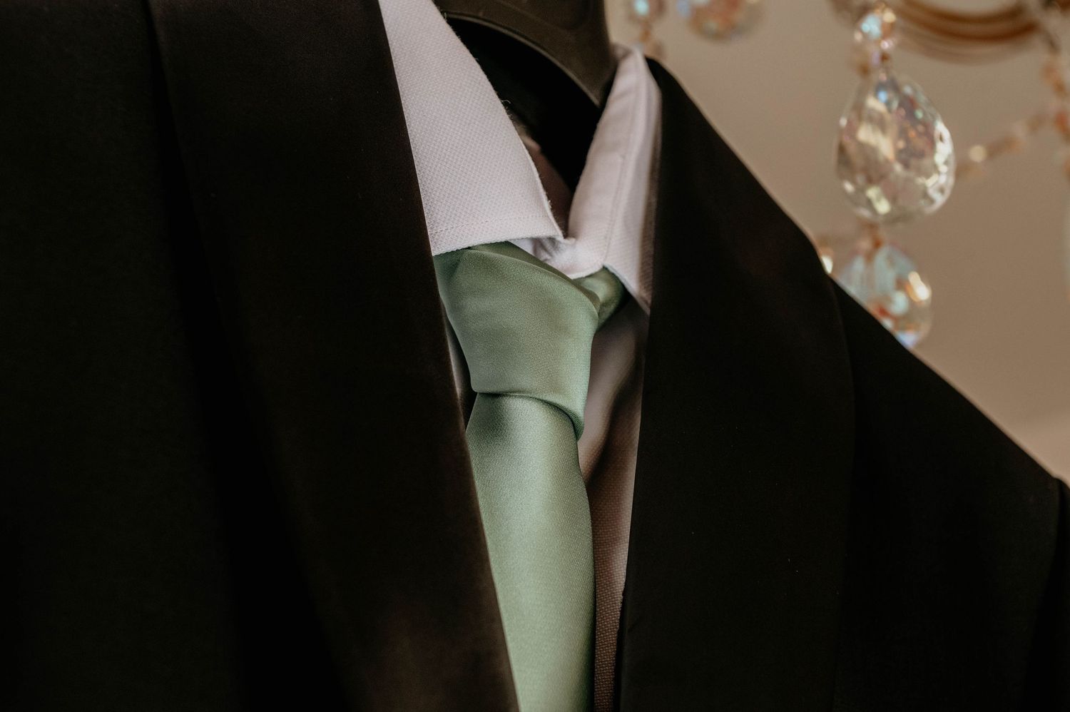 Elegant wedding gowns and dresses hang neatly on display in a bridal boutique interior.