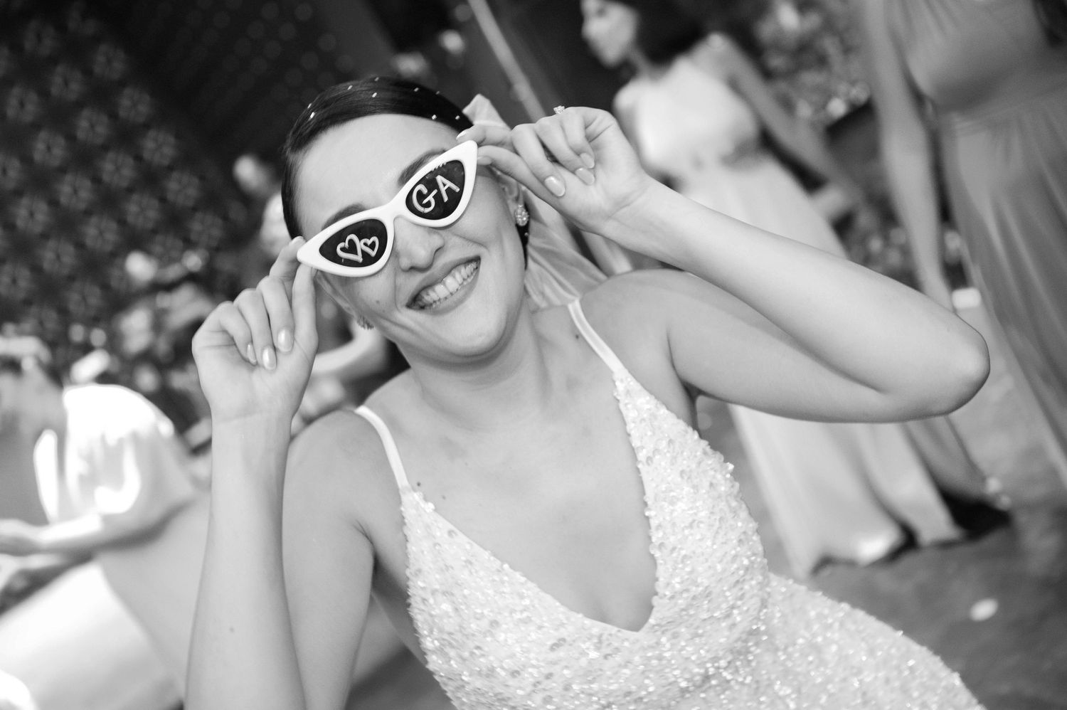 Bridal party celebrates joyfully during a wedding reception on a dance floor.