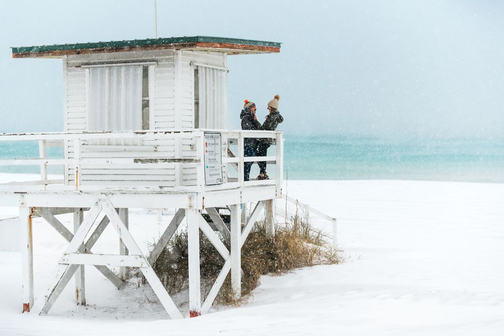 Florida snow storm on Destin and Fort Walton Beach. Matt Johnson Photographer captures couple embracing the once in a lifetime event.