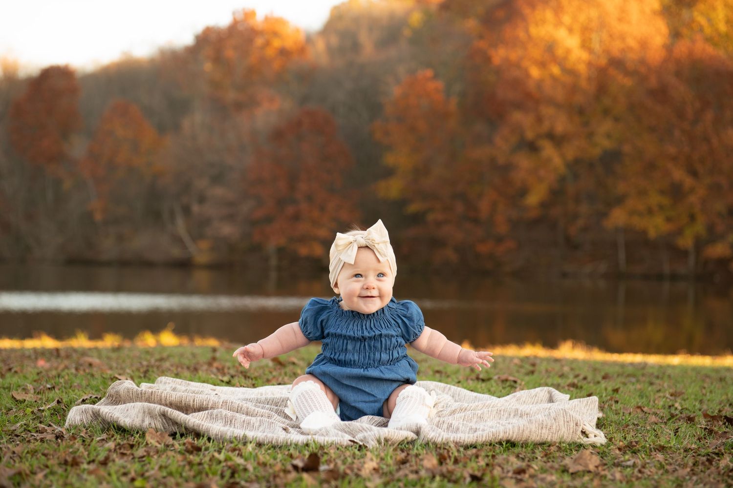 Seven connected autumn photography images showing various poses on a blanket outdoors with orange fall foliage in background.