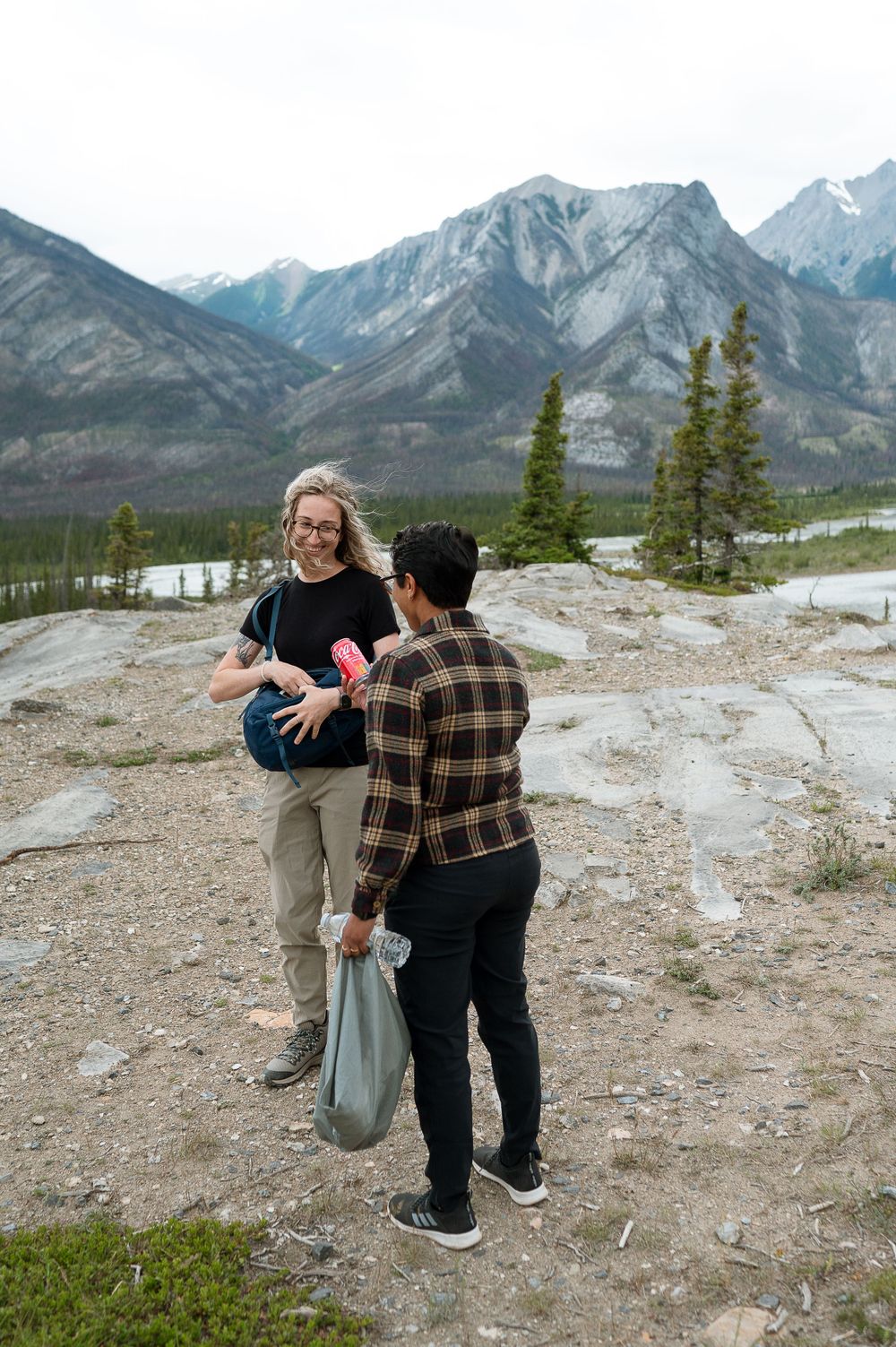 Two people having a conversation against scenic mountain backdrop in Banff.