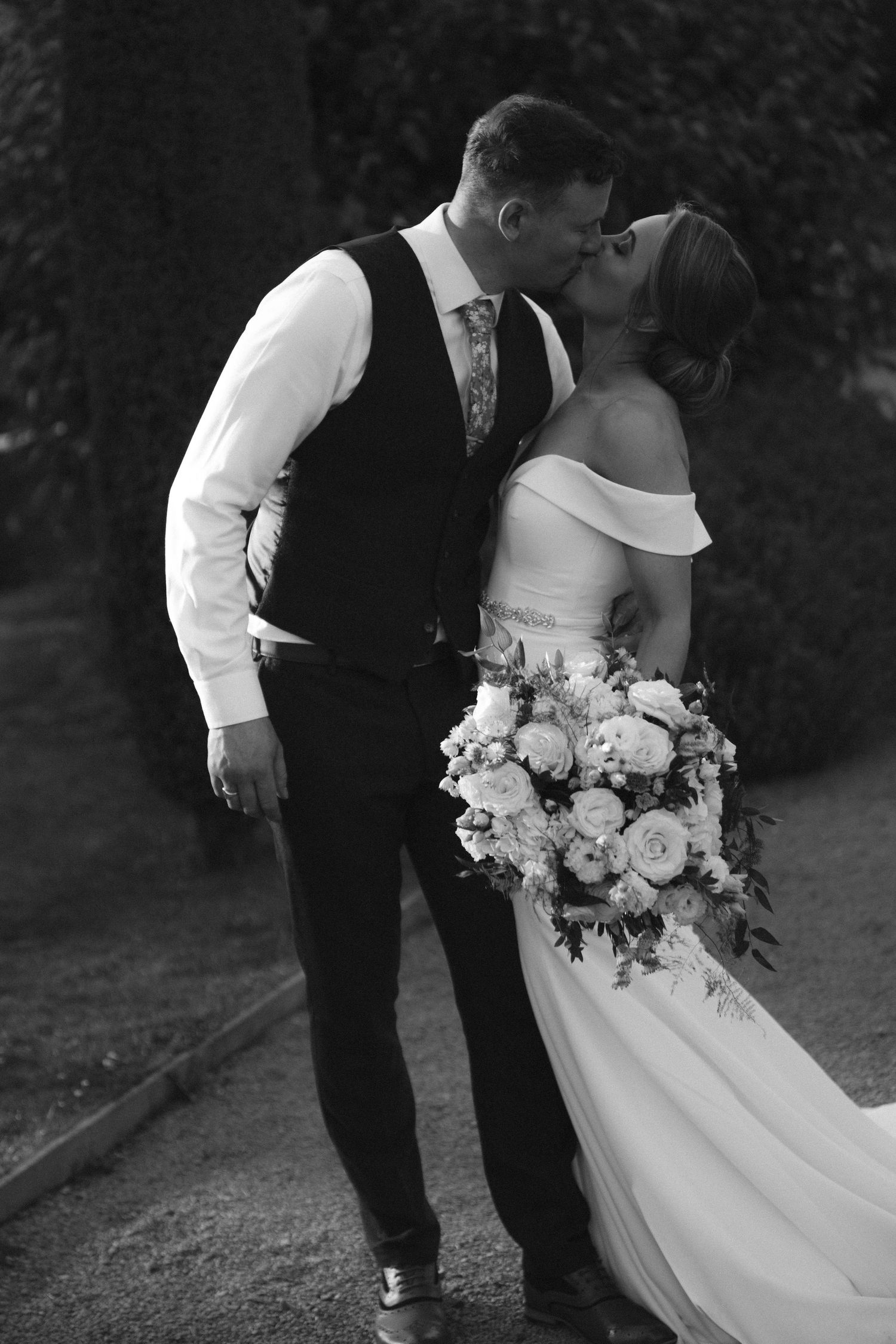 Black and white wedding photo showing couple kissing outside The Prince George Hotel, Halifax, Nova Scotia