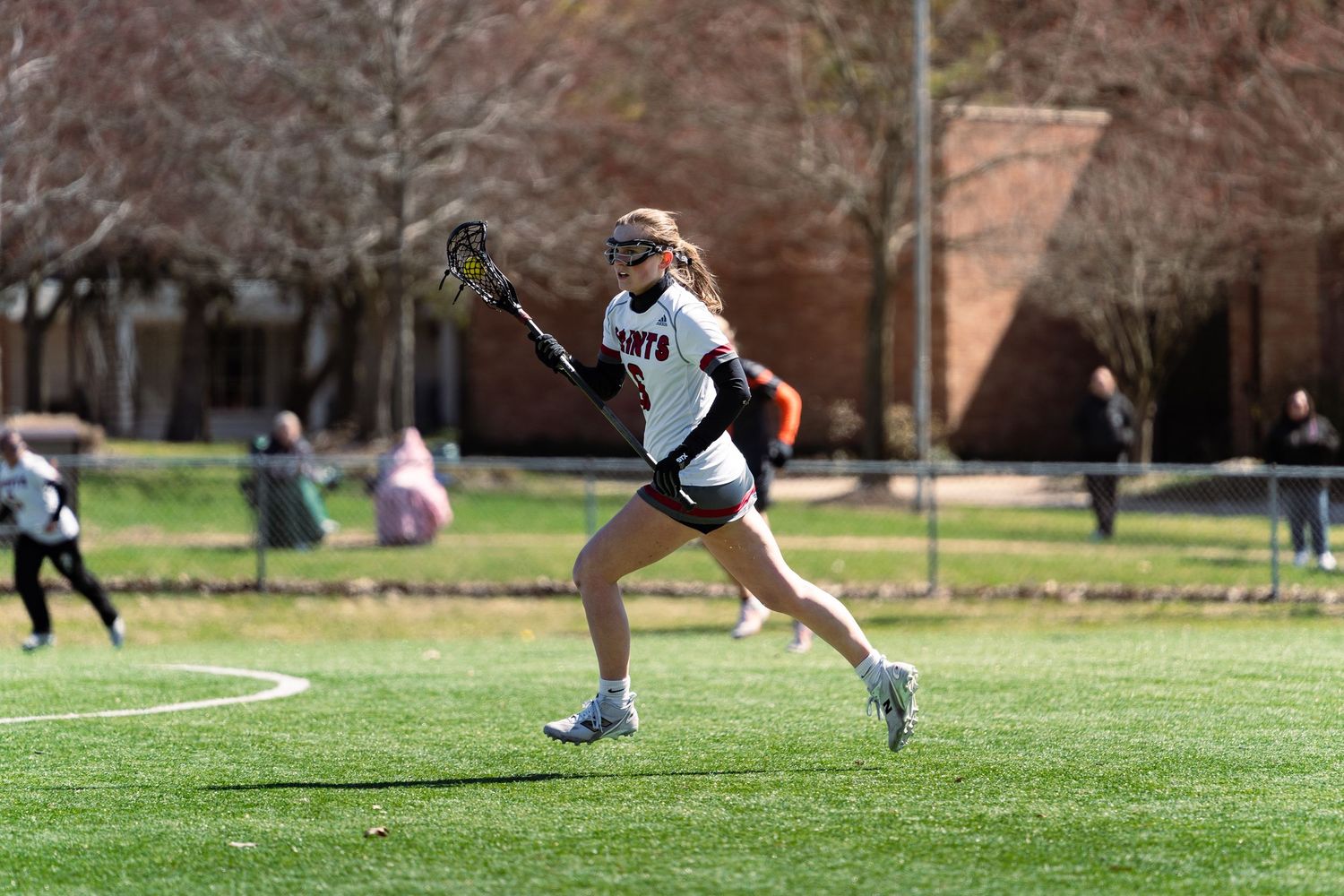 Vanessa Bailey running down the field, Aquinas vs Indiana Tech, Aquinas College Athletic Field, Grand Rapids MI, 3/28/26