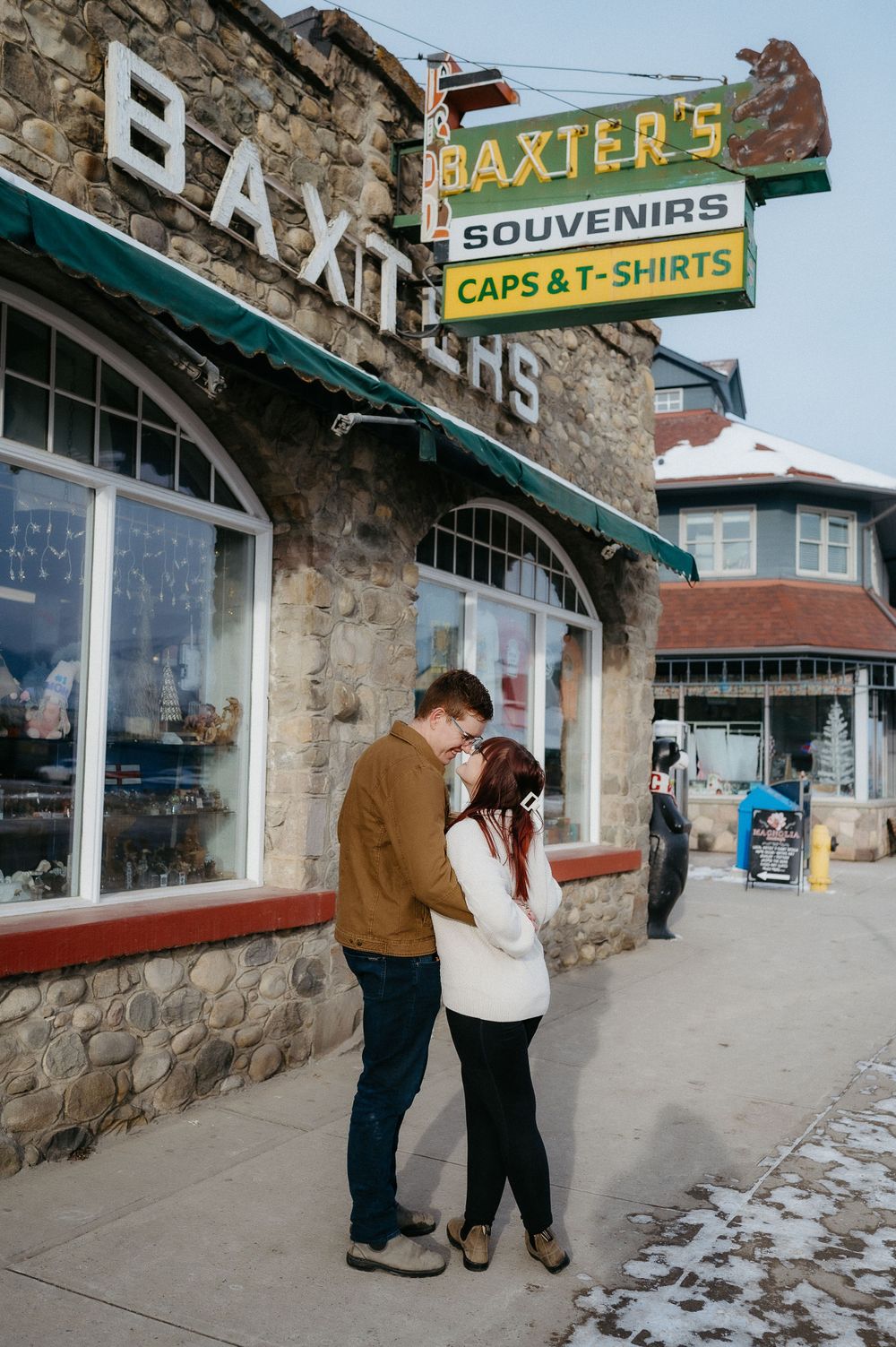 A couple sharing an intimate moment outside Baxter's Souvenirs shop.